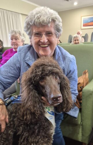 Residents enjoying a visit from Milo from Miracle Paws at Cumberland View Aged Care